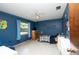 Cozy bedroom with blue walls, white trim, and natural light from the window at 291 Sagewood Dr, Port Orange, FL 32127