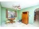 Dining room featuring a ceiling fan, window, small table, and wooden storage cabinet at 291 Sagewood Dr, Port Orange, FL 32127