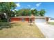 Charming brick home with a manicured lawn and mature trees in a quiet neighborhood at 291 Sagewood Dr, Port Orange, FL 32127