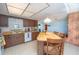 Traditional kitchen with tile floor, wooden cabinets, an island table and white appliances at 291 Sagewood Dr, Port Orange, FL 32127