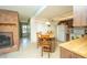 Eat-in kitchen featuring a brick fireplace, island, and a door to the outside at 291 Sagewood Dr, Port Orange, FL 32127