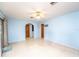 Spacious room with tile floors, ceiling fan, sliding glass doors to outside at 291 Sagewood Dr, Port Orange, FL 32127