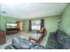 Cozy living room with tile floors, large window, and comfortable leather sectional sofa at 291 Sagewood Dr, Port Orange, FL 32127