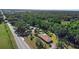 An aerial view of a home with an in-ground pool and wooded area at 2919 Griffin Rd, Leesburg, FL 34748