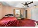 Cozy bedroom featuring red carpet, ceiling fan, and closet at 2919 Griffin Rd, Leesburg, FL 34748