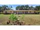 Ranch style home featuring a combination of brick and yellow siding, covered porch, and a large front yard at 2919 Griffin Rd, Leesburg, FL 34748