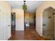View of the front hallway featuring laminate wood floors, a decorative chandelier, and peach painted walls at 2919 Griffin Rd, Leesburg, FL 34748