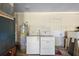 Utility area featuring a washer, dryer, and water heater at 2919 Griffin Rd, Leesburg, FL 34748