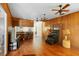 Open living room with a breakfast bar, ceiling fans, and wood paneling at 2919 Griffin Rd, Leesburg, FL 34748