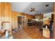 Retro living room featuring wood paneling, ceiling fans, and a wet bar at 2919 Griffin Rd, Leesburg, FL 34748