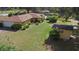 Back exterior view of a single-story home with a large yard and detached shed at 2919 Griffin Rd, Leesburg, FL 34748