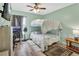 Bedroom with bunkbeds, light gray-green walls, wood-look flooring, ceiling fan, and a mounted television at 2937 Garret St, Deltona, FL 32738