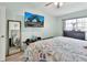 Spacious bedroom featuring light-wood floors, ceiling fan, and mirrored closet door at 2937 Garret St, Deltona, FL 32738