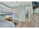 Bedroom with bunkbeds, light gray-green walls, wood-look flooring, and white closet doors at 2937 Garret St, Deltona, FL 32738