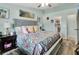 Bright bedroom features a ceiling fan, wood floors, and artwork displayed above the headboard at 2937 Garret St, Deltona, FL 32738