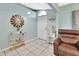 Inviting foyer features tile flooring, neutral wall color, a console table, and a comfortable leather chair at 2937 Garret St, Deltona, FL 32738