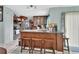 Kitchen with stainless steel appliances, wood cabinets, granite countertops and an island with bar seating at 2937 Garret St, Deltona, FL 32738