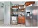 Kitchen with stainless steel appliances, wood cabinets, tile backsplash, and tile flooring at 2937 Garret St, Deltona, FL 32738