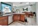 Kitchen featuring wood cabinets, granite countertops, stainless steel appliances, and tile flooring at 2937 Garret St, Deltona, FL 32738