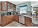 Kitchen with wood cabinets, granite countertops, stainless steel appliances, and tile backsplash at 2937 Garret St, Deltona, FL 32738