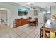 Open-concept kitchen and dining room featuring an entertainment console and tile floors at 2937 Garret St, Deltona, FL 32738