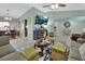 Bright living room featuring a neutral palette, tile floors, vaulted ceilings, and comfortable seating area at 2937 Garret St, Deltona, FL 32738