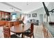 Open-concept kitchen and living room with wood cabinets, granite countertops, and tiled flooring at 2937 Garret St, Deltona, FL 32738