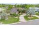 Aerial view of a landscaped property showcasing the circular driveway and mature trees at 3 Whipper In Cir, Ormond Beach, FL 32174