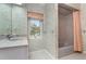 Bathroom with a window, bathtub and shower, decorated with floral wallpaper at 3 Whipper In Cir, Ormond Beach, FL 32174