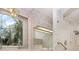 Bathroom with large window, floral wallpaper, chandelier, walk-in shower, and grab bars at 3 Whipper In Cir, Ormond Beach, FL 32174