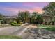 Inviting single-story brick home with a well-manicured lawn, a variety of trees, and a concrete driveway leading to the entrance at 3 Whipper In Cir, Ormond Beach, FL 32174