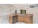 Bright kitchen featuring white tile flooring, stainless steel appliances, and a pass-through to the lanai at 3 Whipper In Cir, Ormond Beach, FL 32174