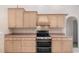 Well-lit kitchen equipped with wooden cabinets, sleek countertops, and stainless steel oven and range at 3 Whipper In Cir, Ormond Beach, FL 32174