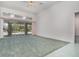 Spacious living room with plush carpeting, high ceilings, and a large sliding glass door leading to the outdoor patio at 3 Whipper In Cir, Ormond Beach, FL 32174