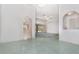 Open living space showcasing arched doorways and a tile floor, creating a seamless transition between rooms at 3 Whipper In Cir, Ormond Beach, FL 32174