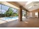 Covered pool area with brick pillars, a small waterfall, and access to the backyard at 3 Whipper In Cir, Ormond Beach, FL 32174