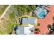 Aerial view of the property and surrounding neighborhood showcasing the roof, deck, and lush greenery at 3000 Ocean Shore Blvd # 6, Ormond Beach, FL 32176