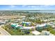 Coastal community view showcasing colorful townhomes, a swimming pool, and proximity to a racetrack at 3000 Ocean Shore Blvd # 6, Ormond Beach, FL 32176
