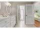 Bright bathroom boasts dual sinks, white cabinetry, and tiled walk-in shower at 3000 Ocean Shore Blvd # 6, Ormond Beach, FL 32176