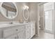 Neutral bathroom features dual sinks, white cabinetry, and tiled walk-in shower at 3000 Ocean Shore Blvd # 6, Ormond Beach, FL 32176