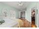 Bright bedroom features wood floors, Murphy bed, and neutral walls at 3000 Ocean Shore Blvd # 6, Ormond Beach, FL 32176