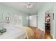 Light bedroom with hardwood floors, closet, a ceiling fan, and dresser at 3000 Ocean Shore Blvd # 6, Ormond Beach, FL 32176