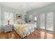Inviting bedroom featuring hardwood floors, plantation shutters, and light, airy decor at 3000 Ocean Shore Blvd # 6, Ormond Beach, FL 32176