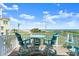 Outdoor deck space boasting ocean view with table and chairs at 3000 Ocean Shore Blvd # 6, Ormond Beach, FL 32176