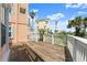 A spacious wooden deck with white railings offers stunning views of the neighborhood and lush greenery at 3000 Ocean Shore Blvd # 6, Ormond Beach, FL 32176