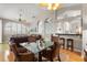 Light and airy dining area with a glass-topped table, wicker chairs, and hardwood floors at 3000 Ocean Shore Blvd # 6, Ormond Beach, FL 32176