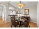 Light-filled dining area with a glass table, wicker chairs, and a view into the kitchen at 3000 Ocean Shore Blvd # 6, Ormond Beach, FL 32176