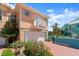 Charming two-story home featuring a balcony, garage, and colorful landscaping against a blue sky at 3000 Ocean Shore Blvd # 6, Ormond Beach, FL 32176