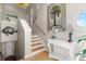 Elegant staircase featuring neutral tones, wood steps, and a palm tree art piece at 3000 Ocean Shore Blvd # 6, Ormond Beach, FL 32176