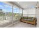 Bright sunroom offers seating, natural light and view of the outdoors at 3000 Ocean Shore Blvd # 6, Ormond Beach, FL 32176
